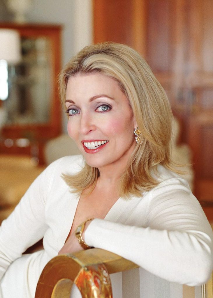 Headshot of the featured interior designer in a white cardigan