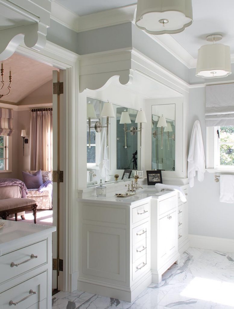 The vanities in the master bathroom are accented with scroll-cut brackets above the mirrors to visually lend additional height
to the space.