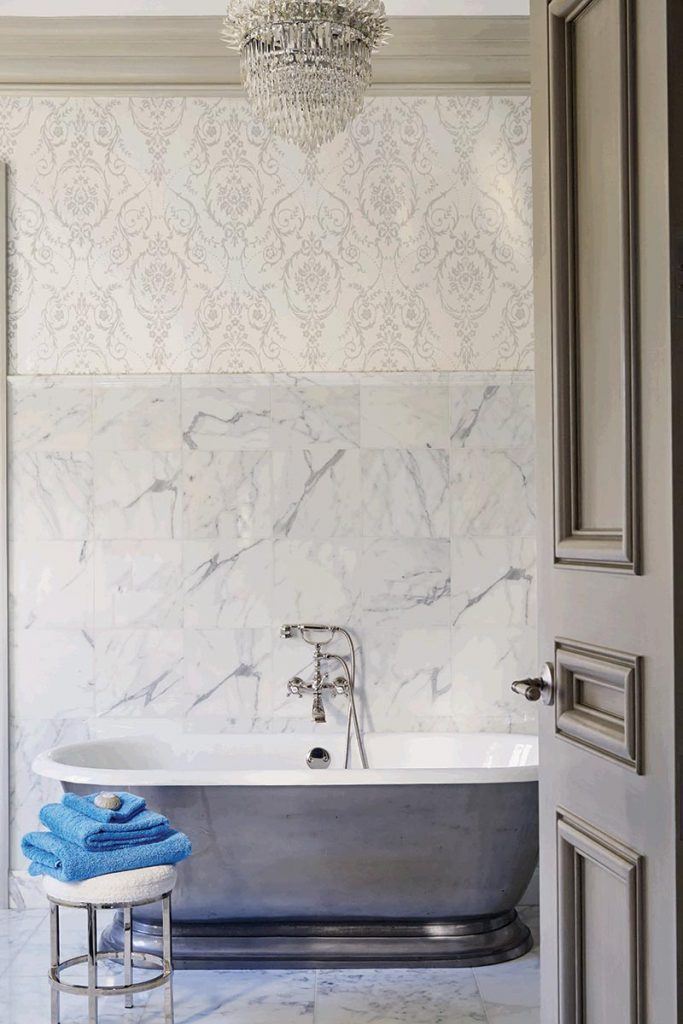 In the bathroom, a tone-on-tone damask echoes the veining of the marble floors and walls.