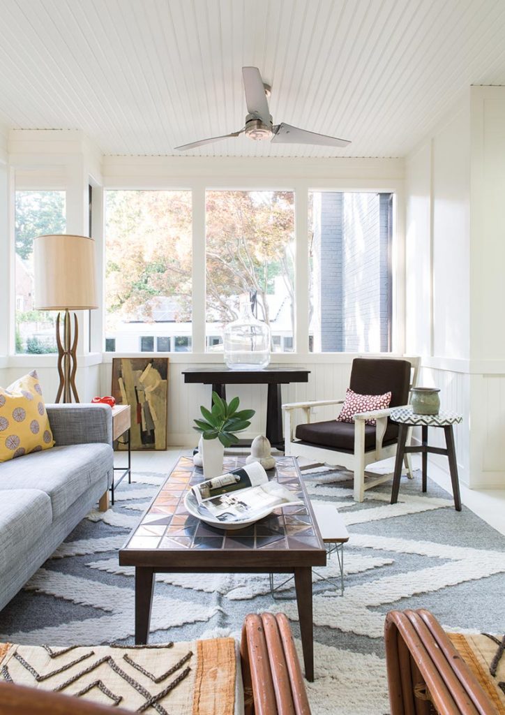 The new screened porch was a priority for the homeowners. A mixture of budget-friendly online finds creates an enchanting hangout. The sofa is from IKEA; the coffee table and rug are from West Elm.