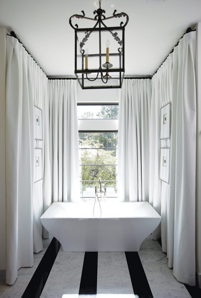Drapery panels surround the bathing alcove in the master bath.