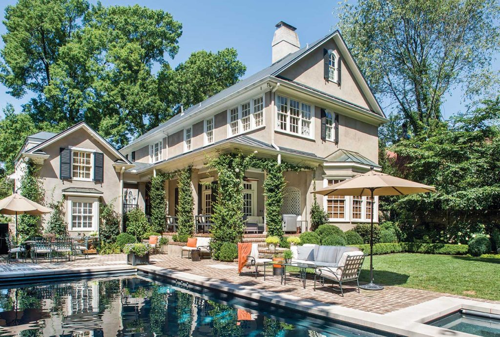 The backyard offers the essence of indoor-outdoor living—a covered porch, separate areas for entertaining, and a beautiful pool.
