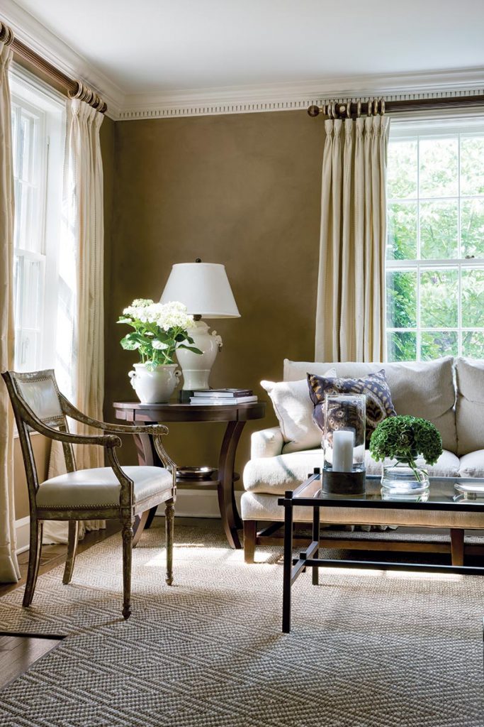 Vogt loves to add a shiny element to each room. In the living room, gold-toned étagères create a nice contrast to the more neutral tones of the upholstery and walls.