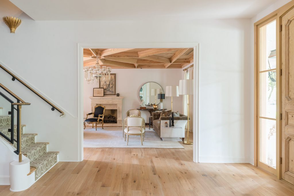 Nineteenth-century doors from Bourgoin Avignon, France—found at Houston’s Chateau Domingue—lead the way into the entry hall, which features a mixed-metal staircase made by a local Texas artisan.