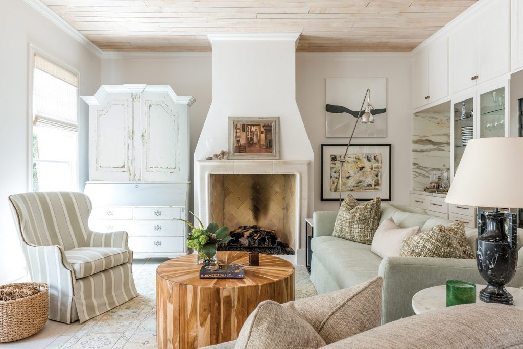 Knocking down a utility wall allowed space for the new custom limestone fireplace in the keeping room.