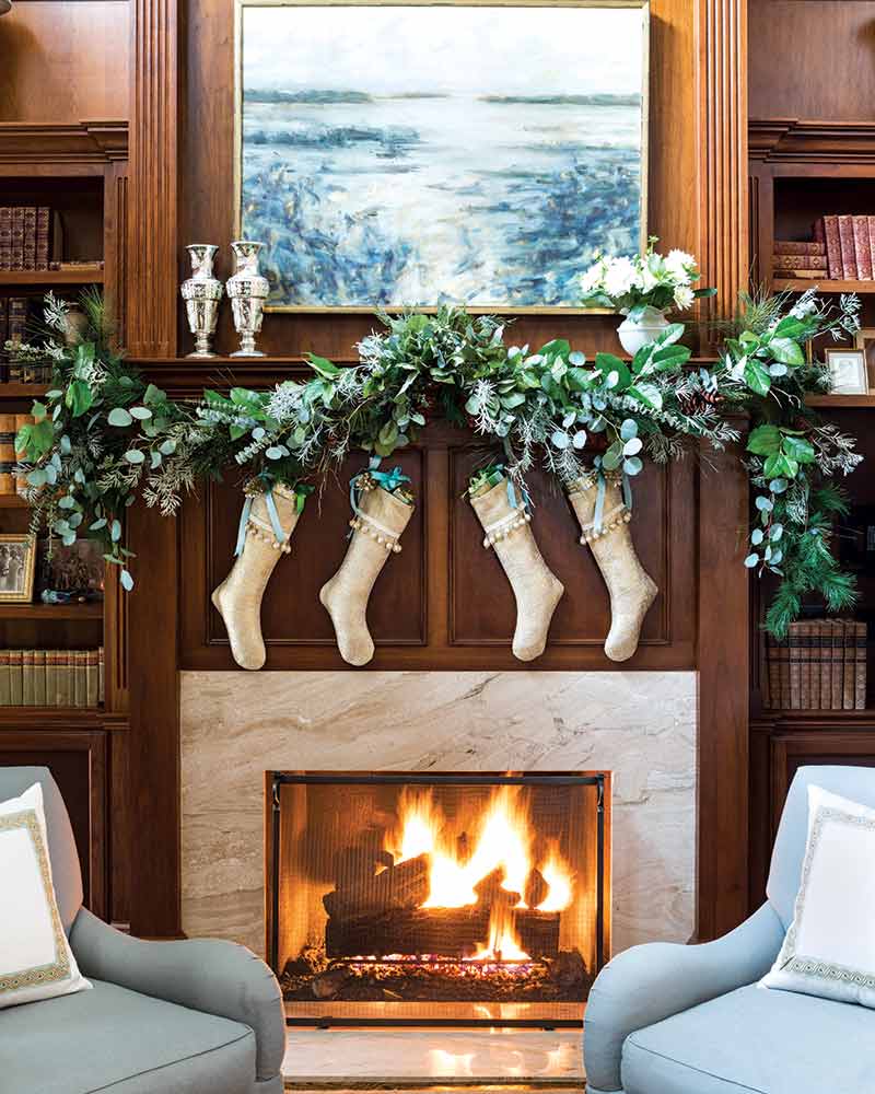 fireplace, stockings, and eucalyptus greenery