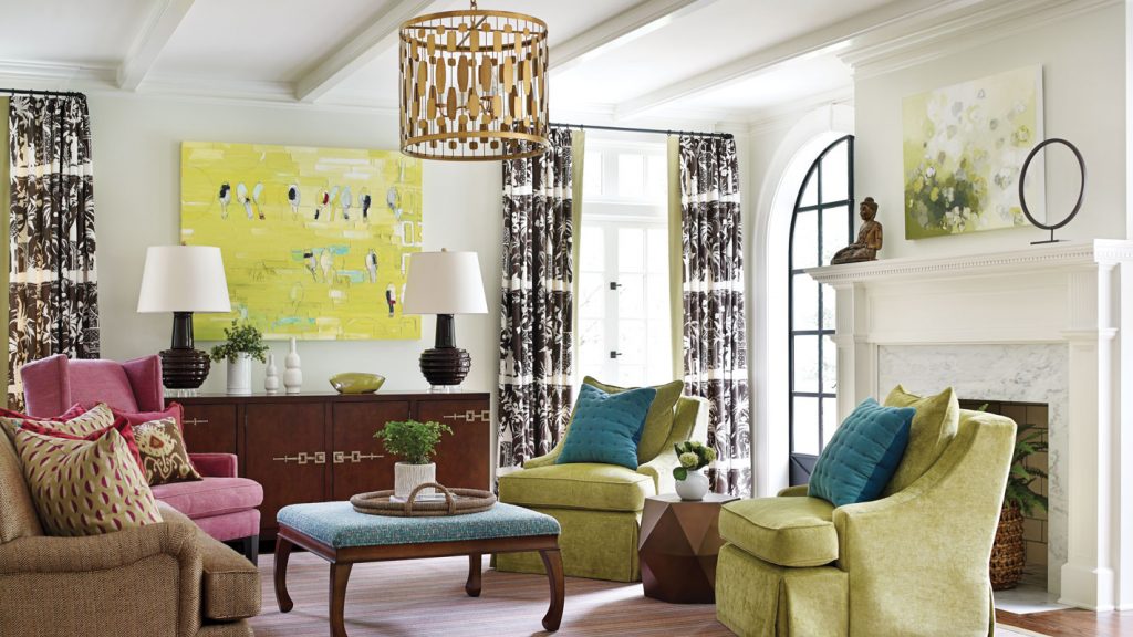 Living room with chartreuse chairs, a turquoise ottoman and a yellow canvas
