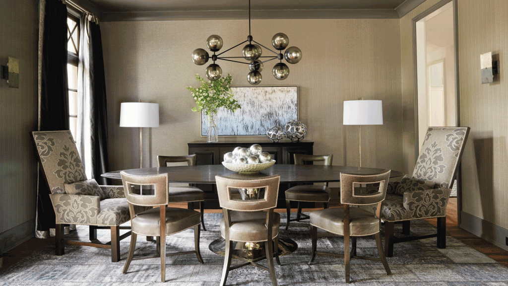 Dining room with patterned chairs, a dark table and a modern chandelier