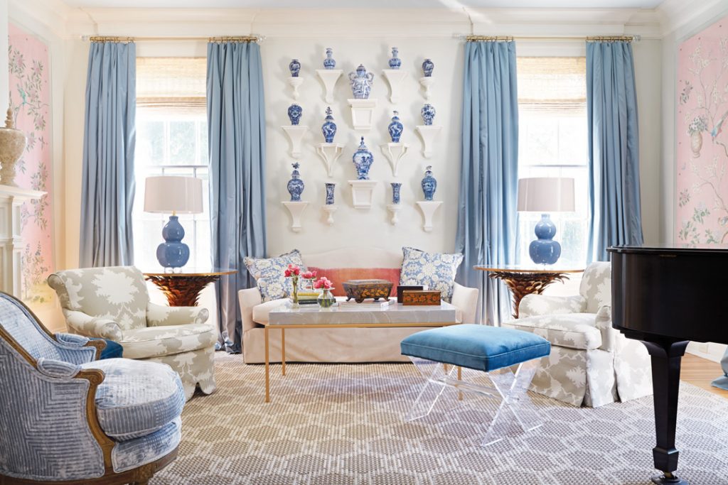 Sitting room with blue-and-white porcelain on the wall and a black piano