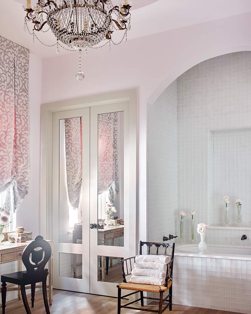 Blush pink master bathroom with tall mirrored doors