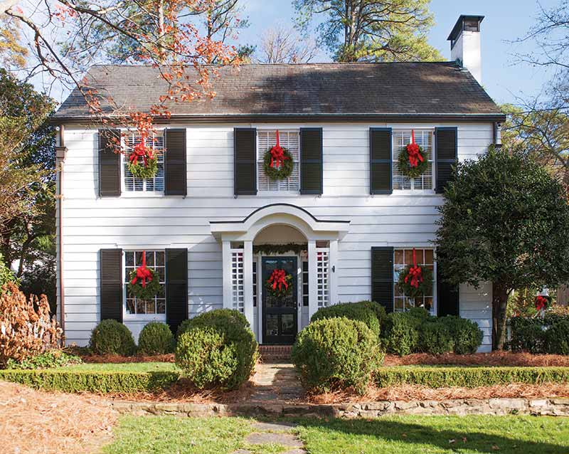 colonial white exterior decorated with Christmas wreaths