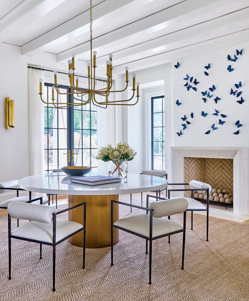 Dining room with a brass chandelier and blue butterflies on the wall