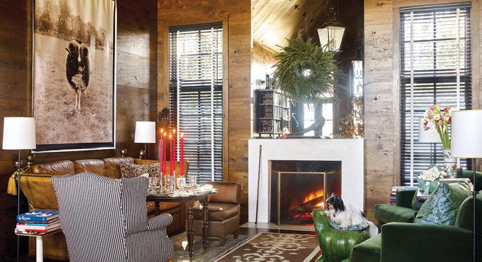 This North Carolina Home is An Enchanting Winter Escape wood-paneled living room with fireplace