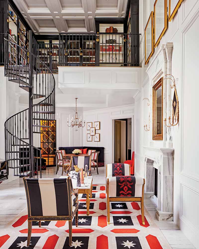 parlor with black spiral staircase leading to library