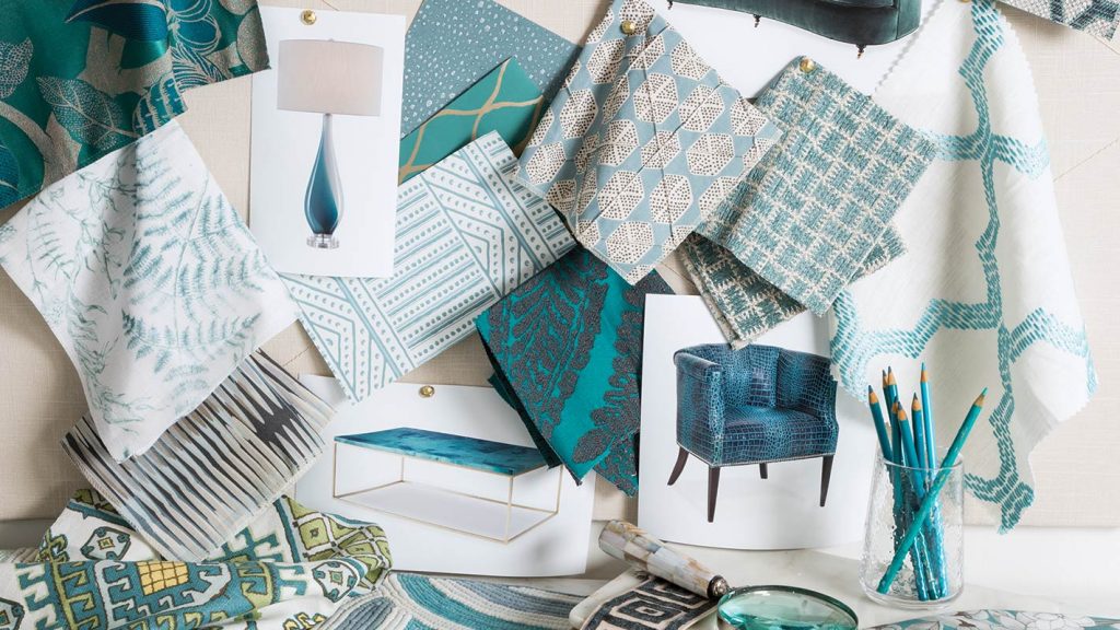 Flat-lay of teal and blue fabric swatches, tile samples and coral pieces