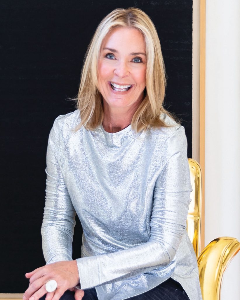 Portrait of a woman in a silver top seated in a gilt chair