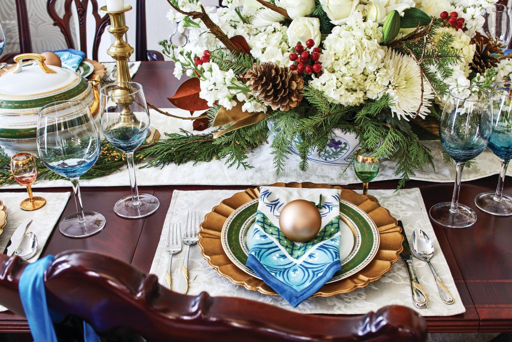 Holiday table with a white hydrangea centrepiece and blue glassware