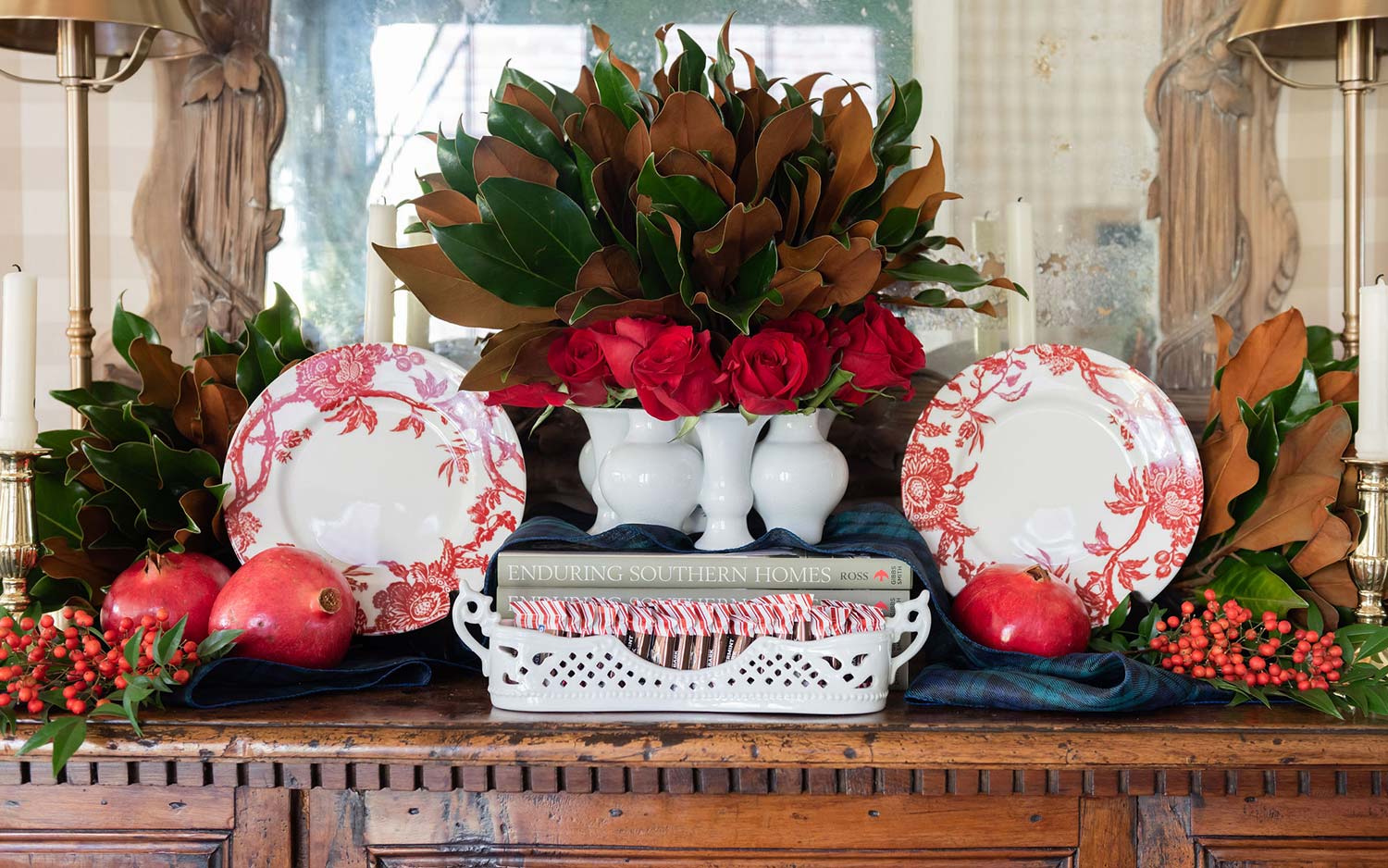 Sideboard with magnolia and pomegranate arrangements and red transferware