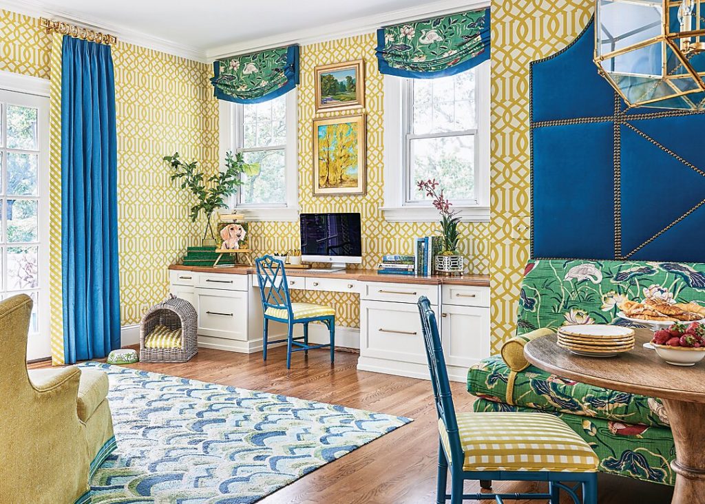 Yellow trellis-papered breakfast room with blue curtains and a blue mural