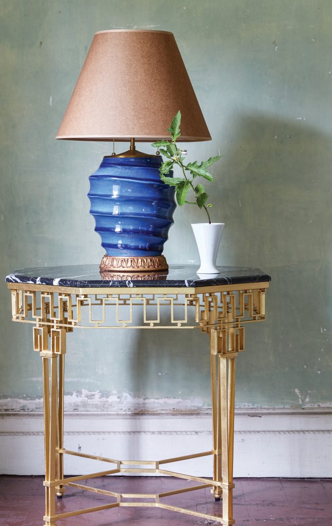 Blue ginger jar lamp on a brass and glass side table