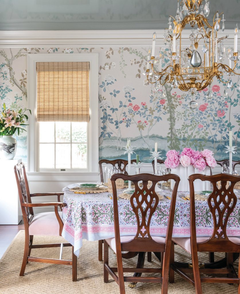 Dining room with floral wallpaper, a gilt screen and shield-back chairs