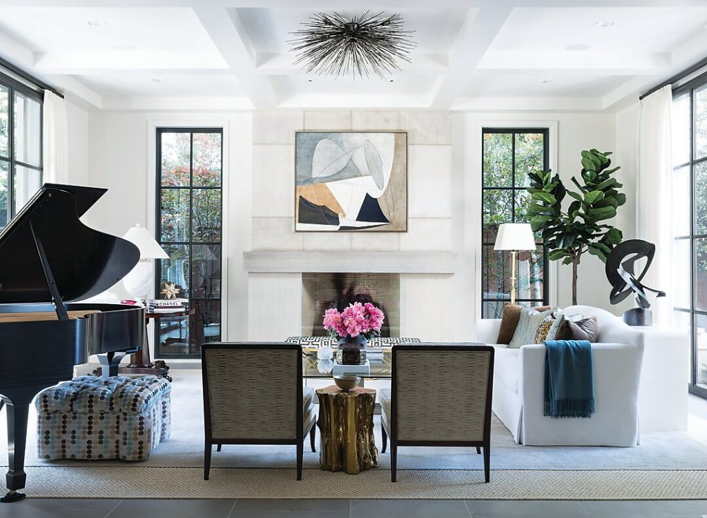Living room with a black grand piano, limestone mantel and steel windows