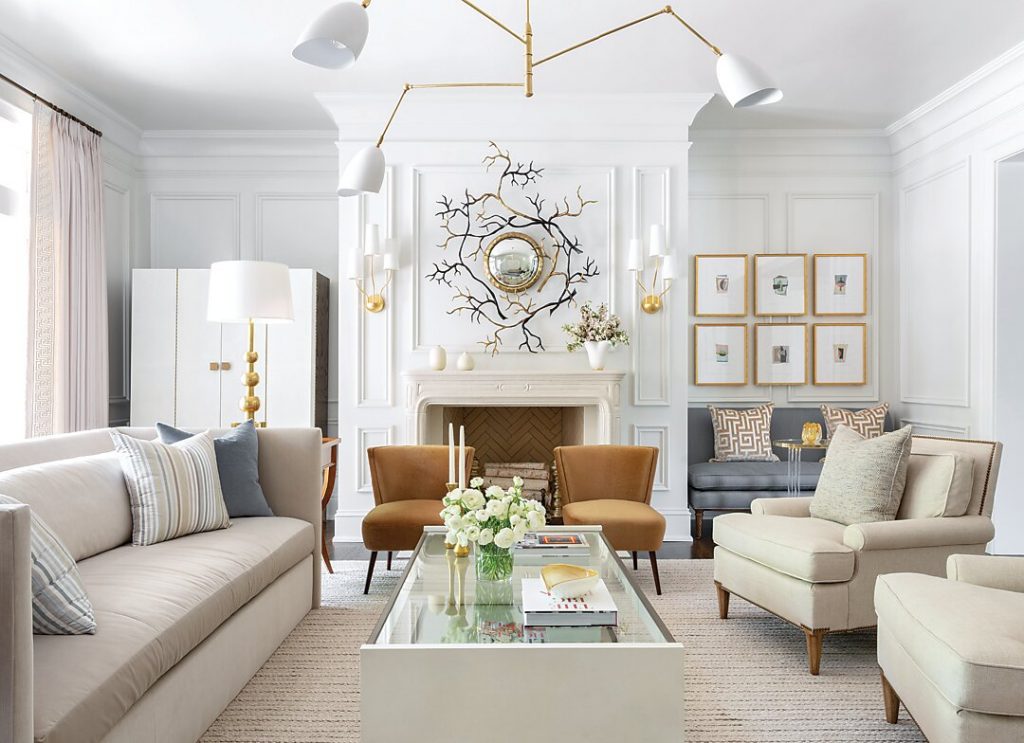 The home’s mix of traditional and contemporary is especially pronounced in the living room, where such elements as a pair of French-influenced chairs are seen alongside a large-scale brass-and-shagreen coffee table.