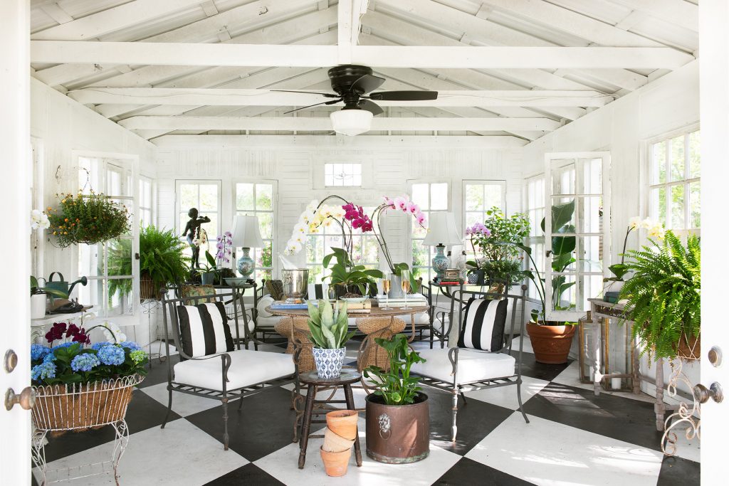 Sunroom with black-and-white striped chairs on a checkerboard floor