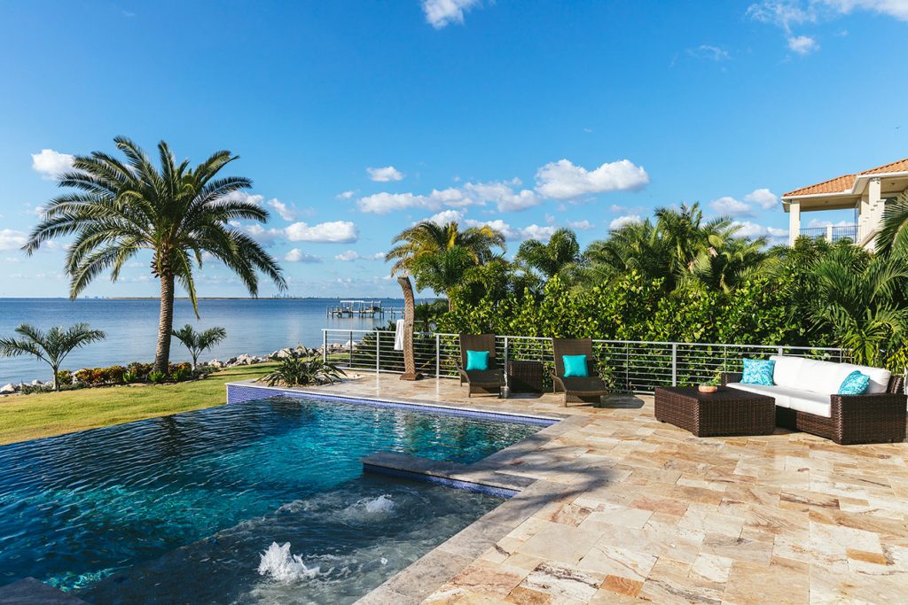 Infinity pool and palms overlooking the water