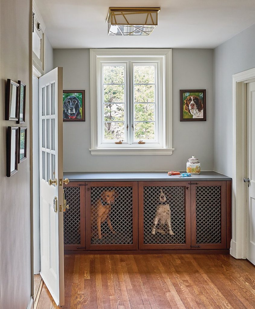 Hall with a caned console, framed portraits and a wood floor