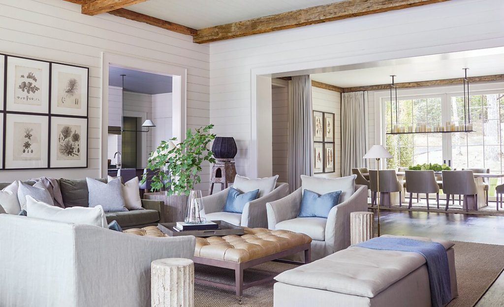 The home’s expansive family room is ideal for hosting a large crowd. Interior designer Liz Hand Woods gave the space four chairs, a sofa, a bench, and a banquette, all perfect for watching football games or just relaxing in the evening. Botanical prints representing a series of pinecones adorn the wall—paying homage to the abundance of pine trees on the property.