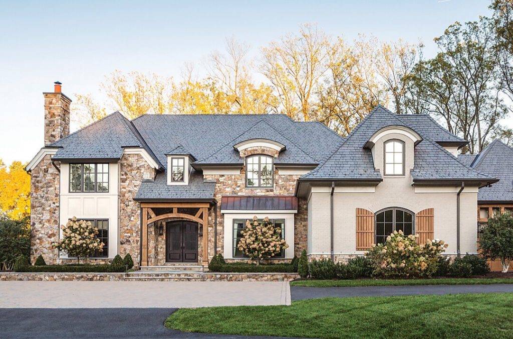 Stone and stucco house with steep gables and a slate roof