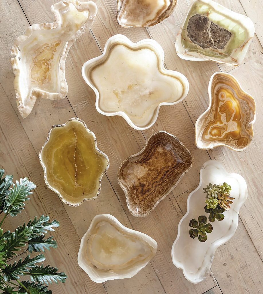 Agate coasters and shell dishes arranged on a white surface