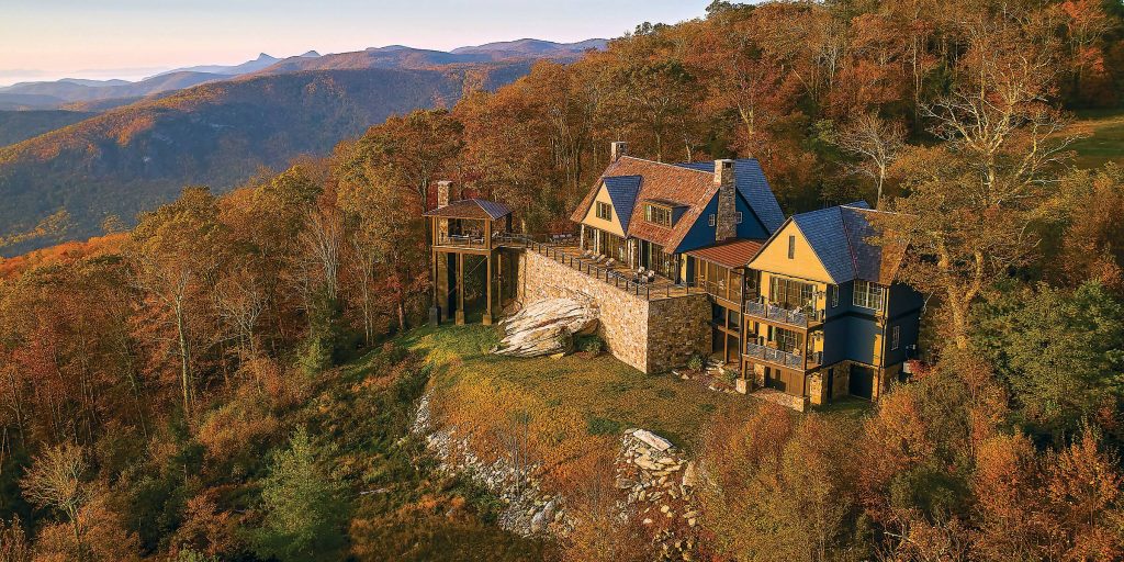 Atop a mountain in Linville, North Carolina, a new house offers views of the distant hills from both within the house and from exterior terraces and a pavilion.