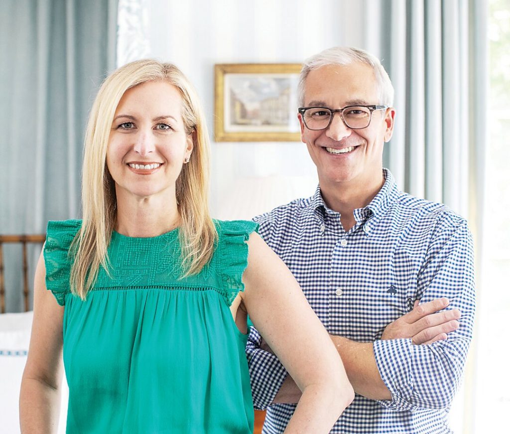 Couple standing together in a sunlit room