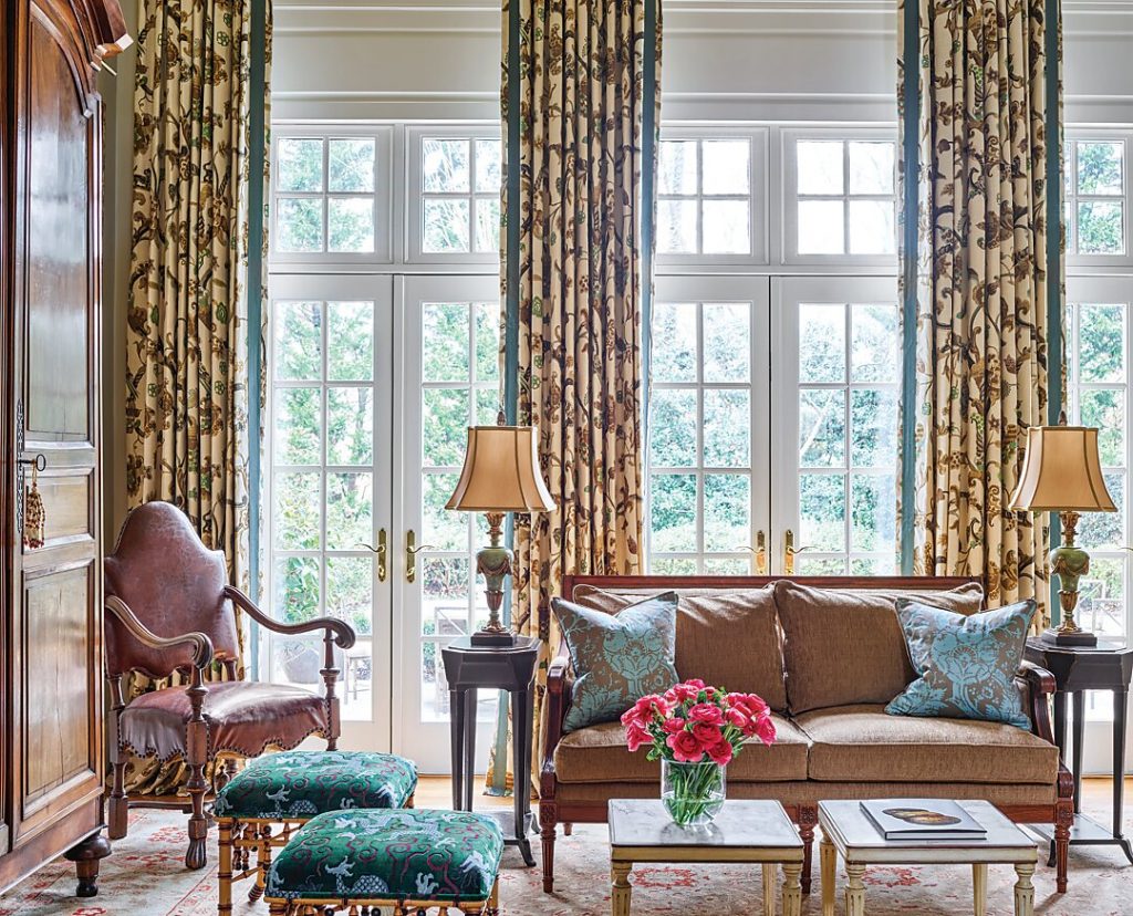 Living room with floral curtains, a settee and antique chairs