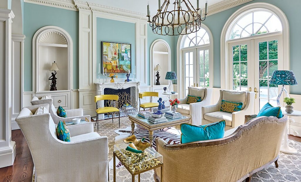The living room is bathed in a soothing blue with punches of color.