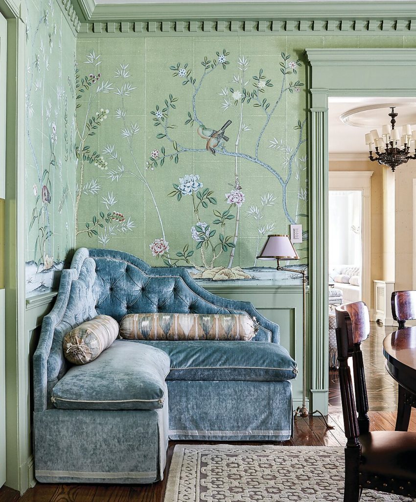 Blue velvet chaise against green chinoiserie wallpaper