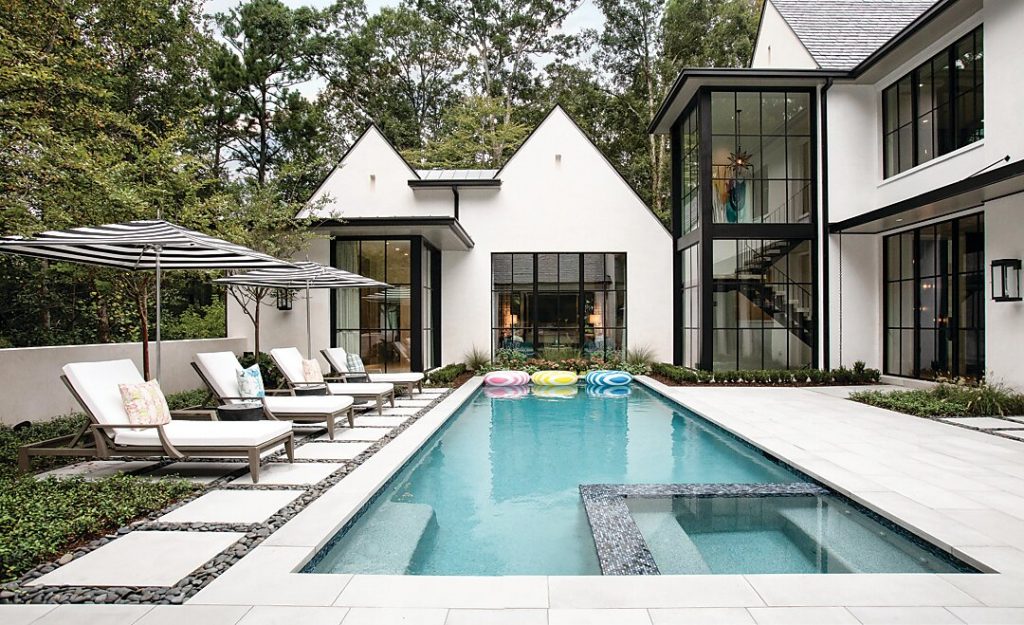 This Tudor-style Buckhead home features a two-story steel-and-glass stair tower designed by Atlanta architect Tim Adams.