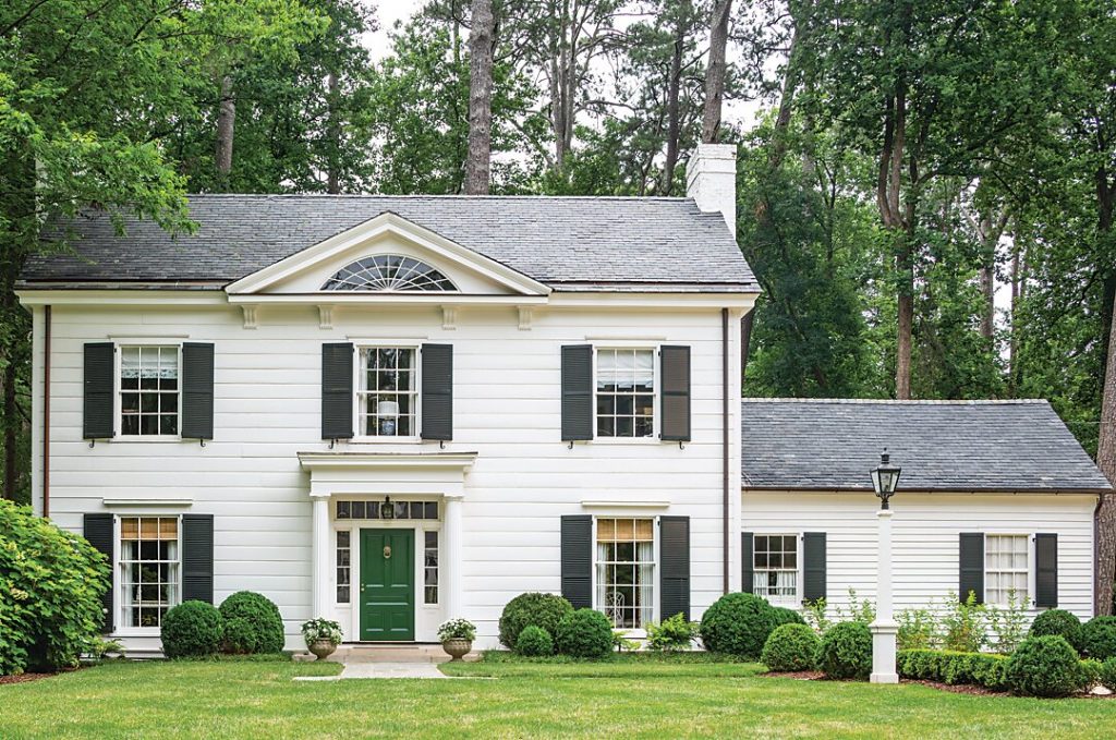 White house with a pedimented entry and black shutters