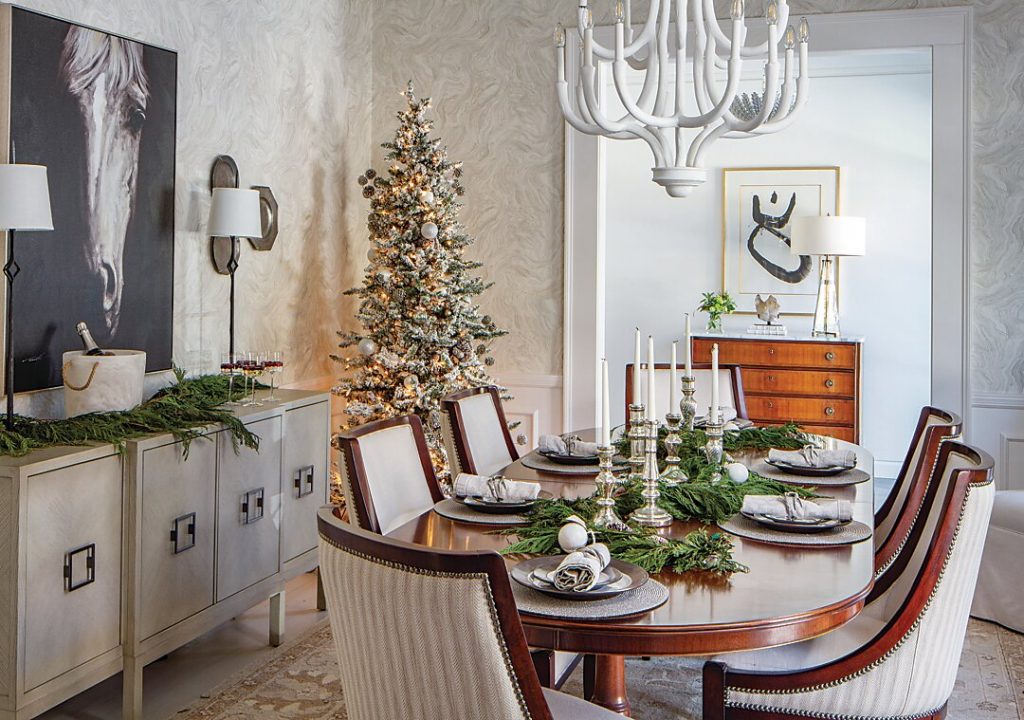 Dining room with a slim decorated tree, plaster sideboard and greenery