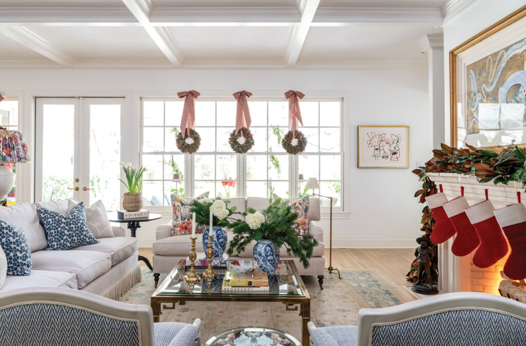 Living room with stockings hung at the windows and blue sofas