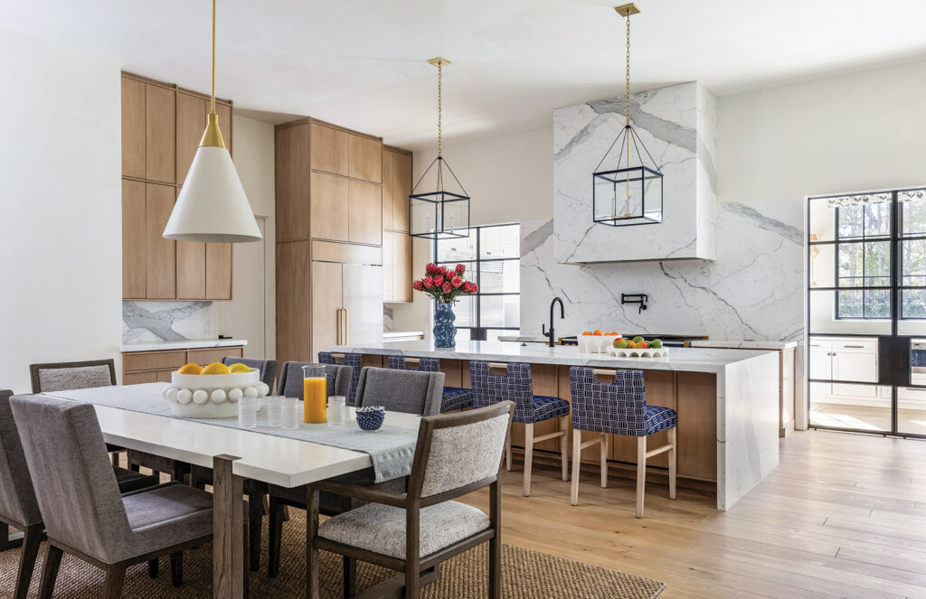 Kitchen and dining space with oak cabinets and navy patterned chairs