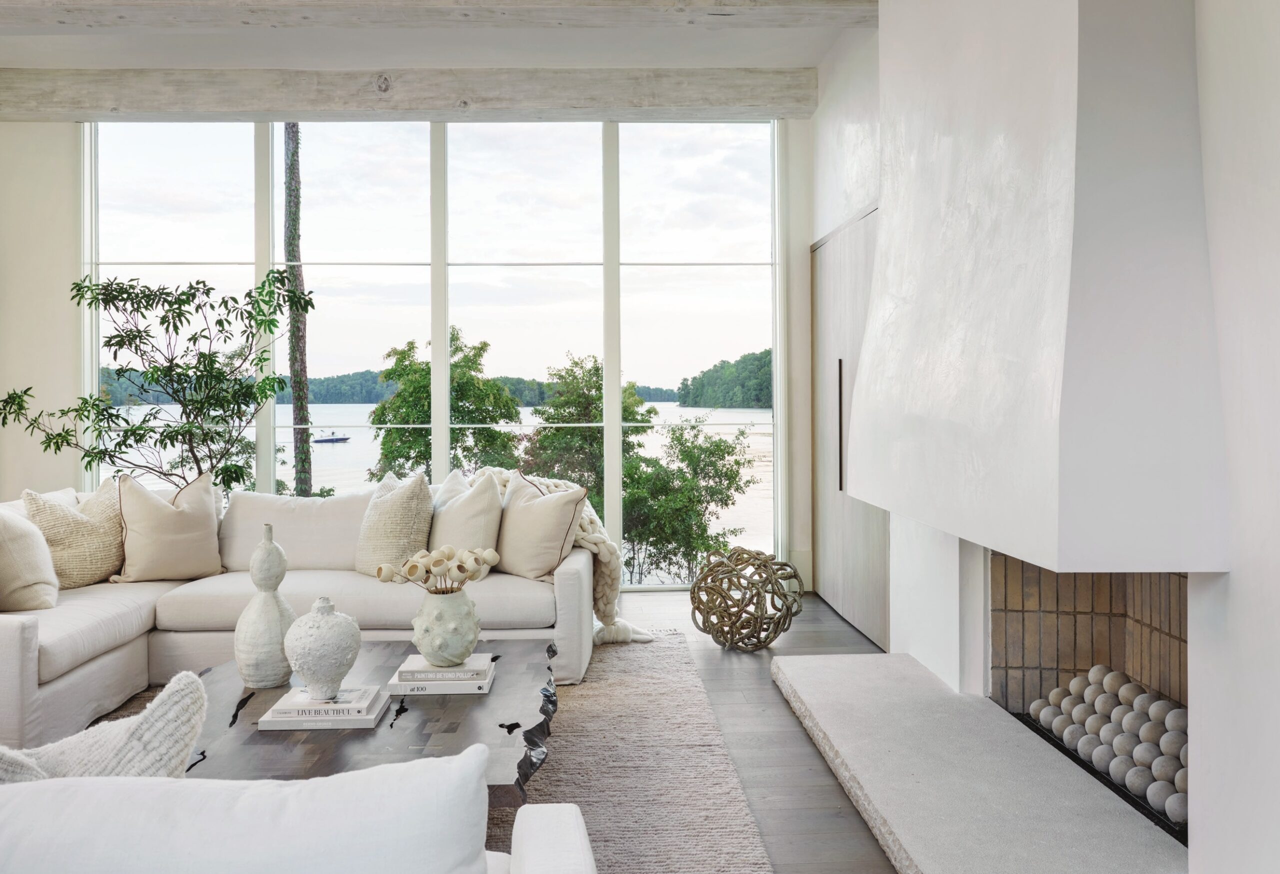 Luxuriously deep seating from Verellen pairs with a raw-edge coffee table from BDDW, infusing the elegant living room with a touch of rusticity.