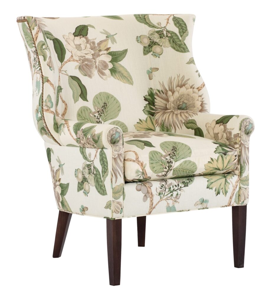 Lee Industries wing chair upholstered in a green and cream botanical print with rolled arms and dark pecan legs