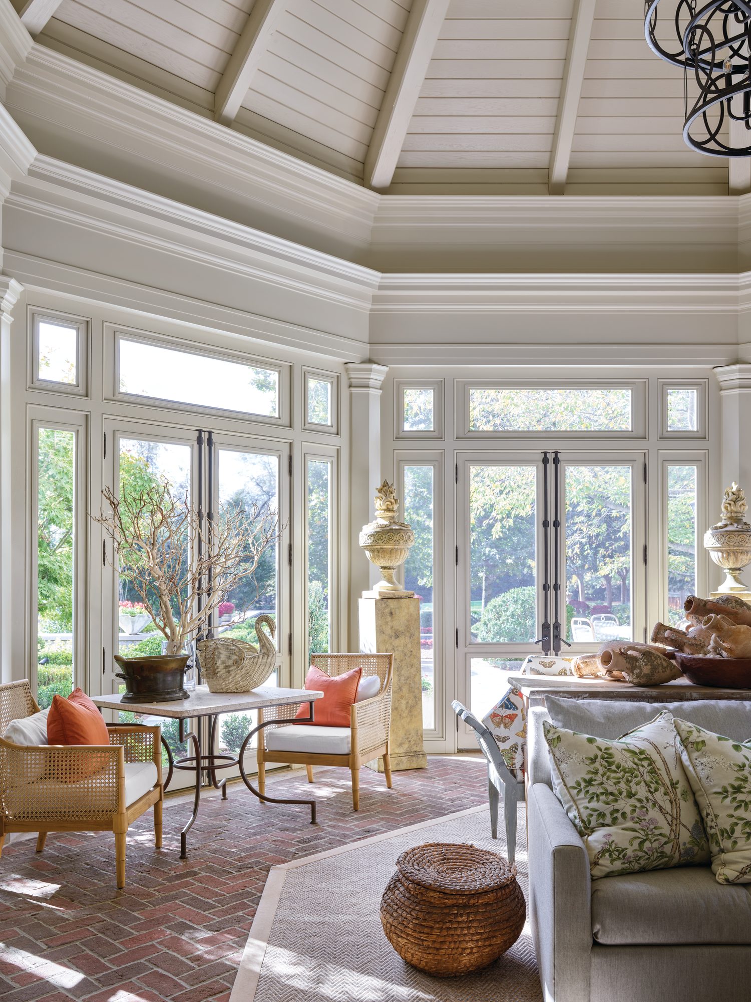 Octagonal sunroom, formerly a screened porch, with a vaulted beamed ceiling, windows on every side, and a brick floor