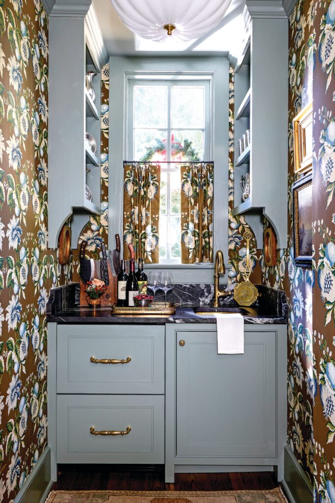 Former cook’s closet converted into a bar wrapped in Lee Jofa Jessup wallcovering with blue-painted cabinets