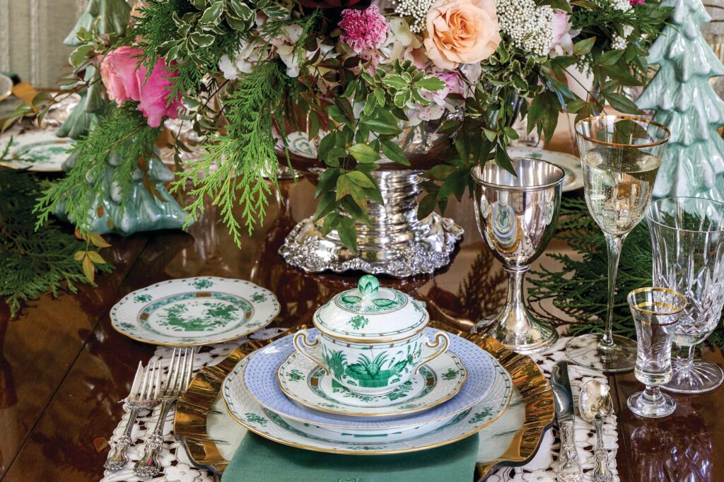 Holiday table set with Annieglass chargers, green Herend china, vintage silver, and crystal stemware