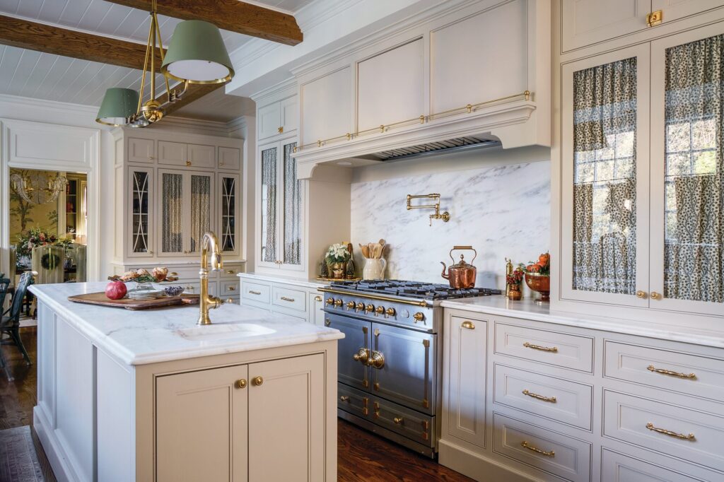 Classic kitchen with creamy custom cabinetry, Imperial Danby marble, and a stainless steel La Cornue range