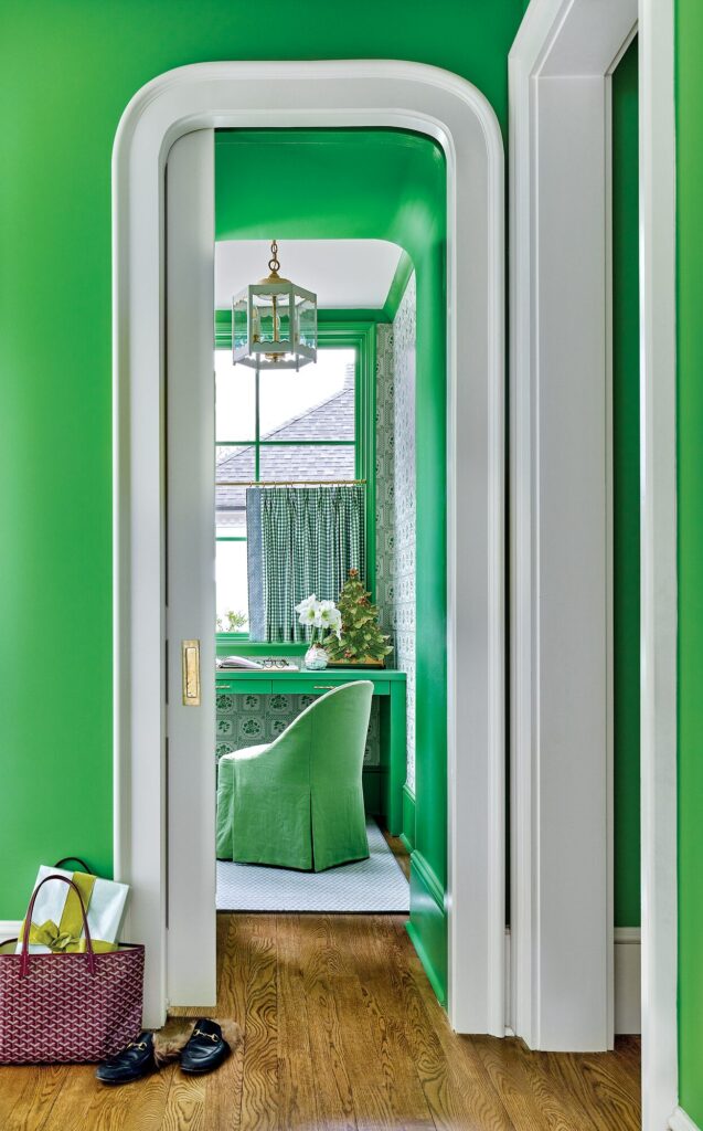 Bright green planning office painted in Behr Pesto, seen through a doorway